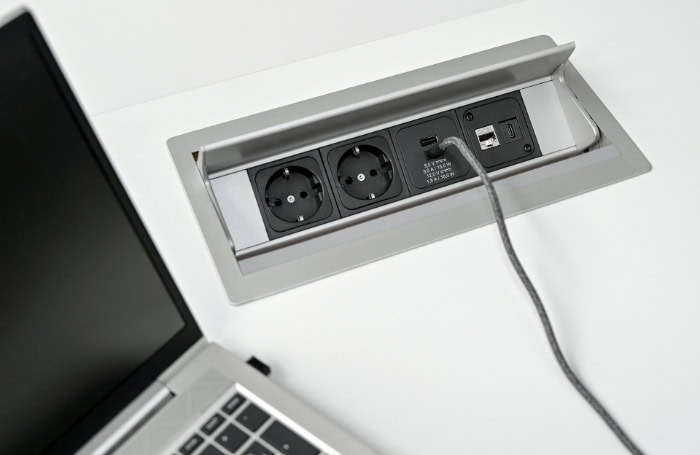 Built in desk power strip with multiple outlets and USB ports