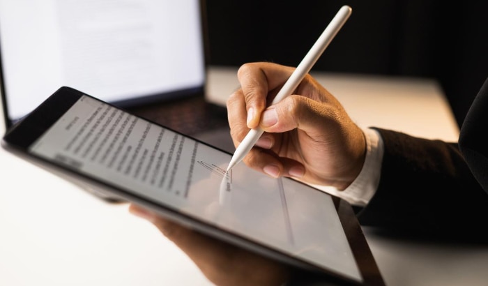 Businessman sign a document on tablet