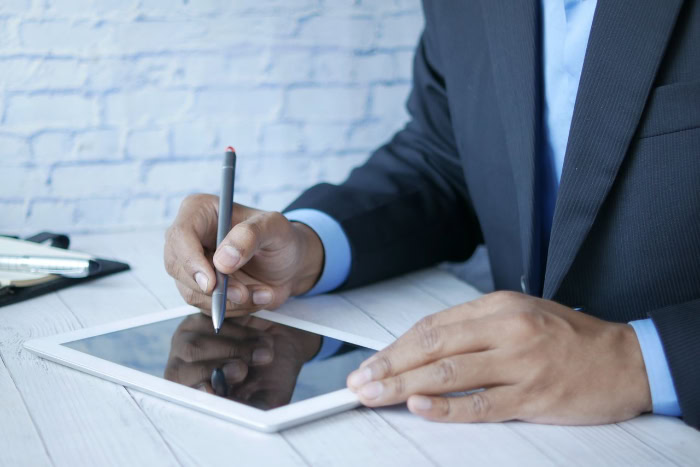 Businessman using a stylus pen on a tablet