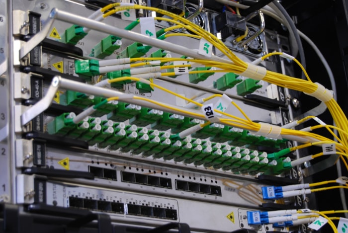 Green and yellow cable network in racks