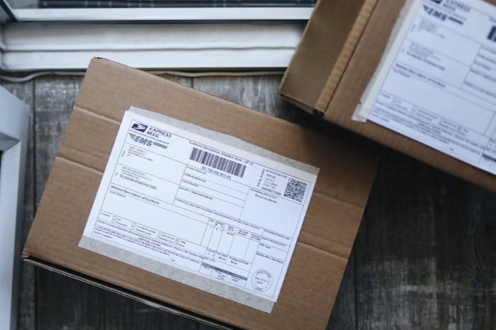 Cardboard shipping boxes with barcode labels on doorstep