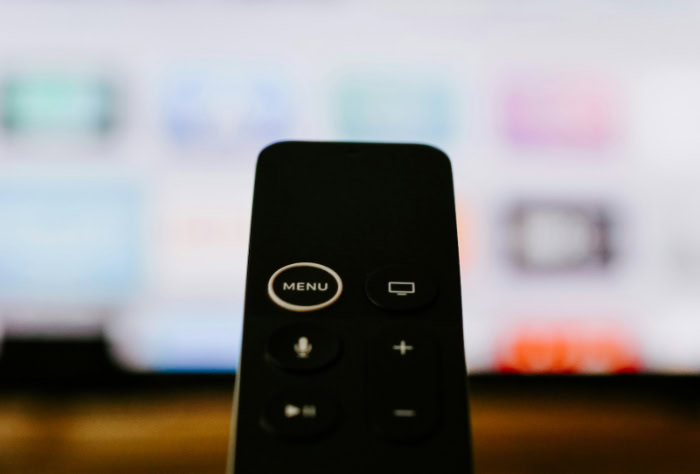 Close up of Apple TV remote with blurred background