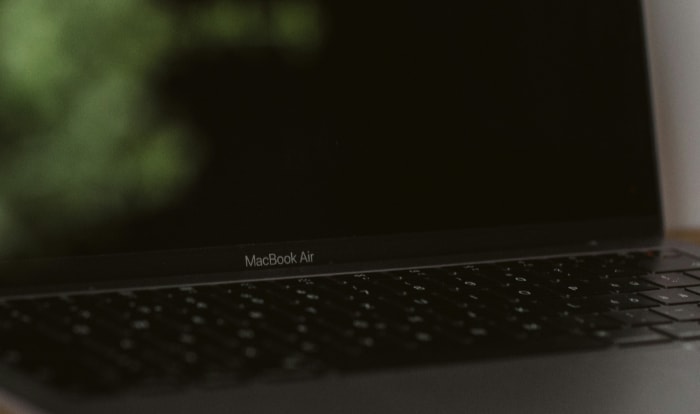 Close up of a MacBook Air showing its name on the display hinge