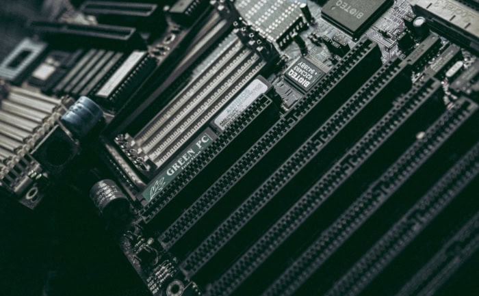 Close up of a dark computer motherboard with electronic components