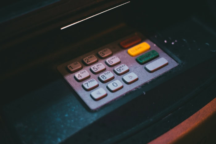 Close up of a dimly lit ATM keypad