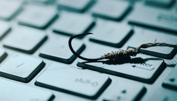 Close up of a fish hook on a computer keyboard