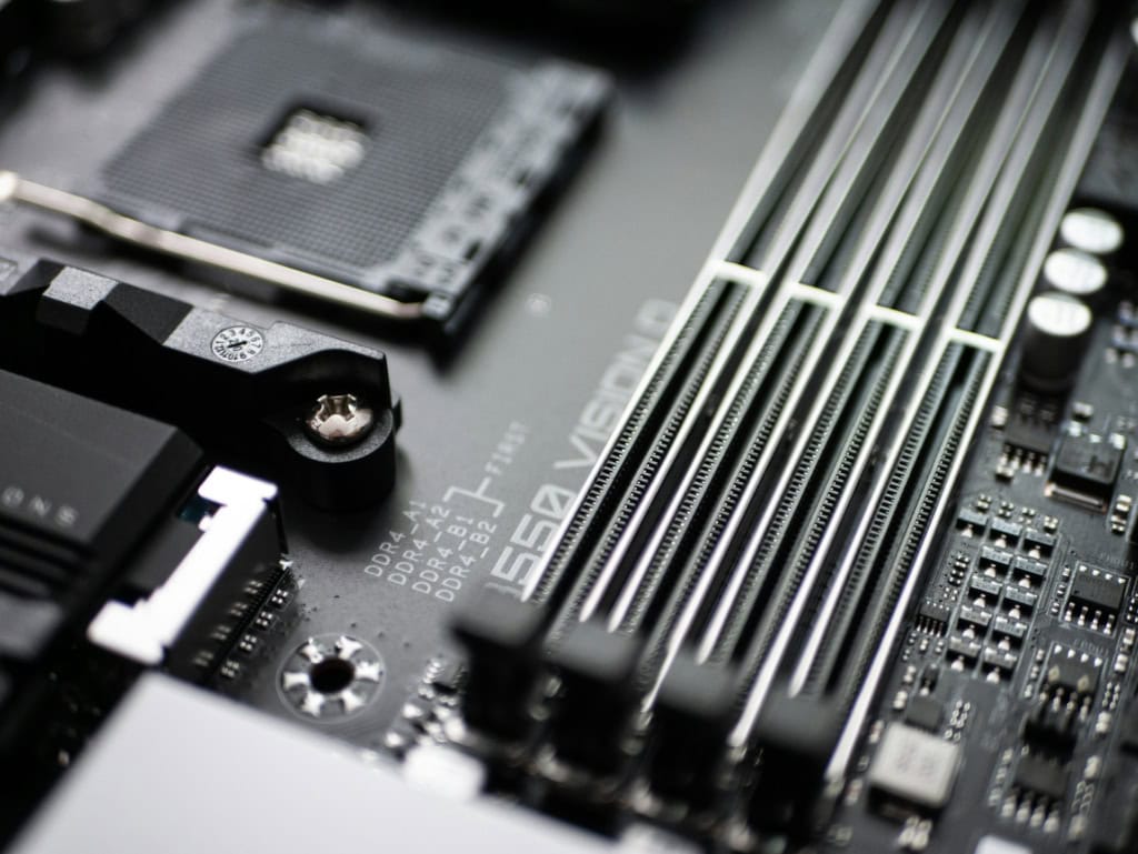 Close up of a motherboard showing DDR4 RAM slots and CPU socket