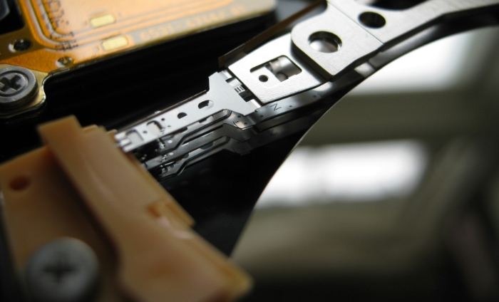 Close up of an internal hard drives read or write head and platters