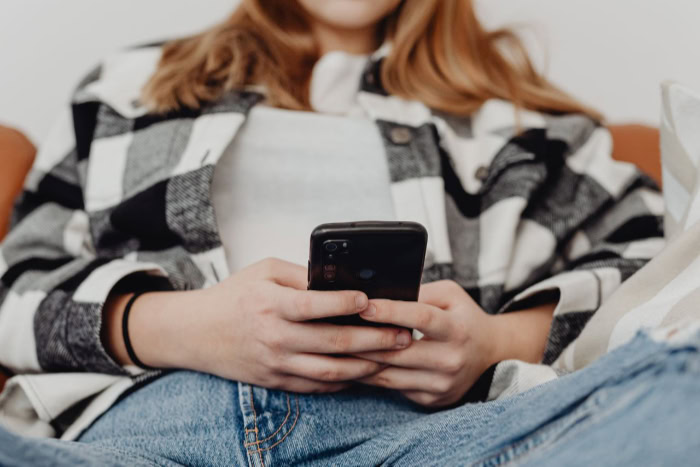 Close up of hands holding and using smartphone
