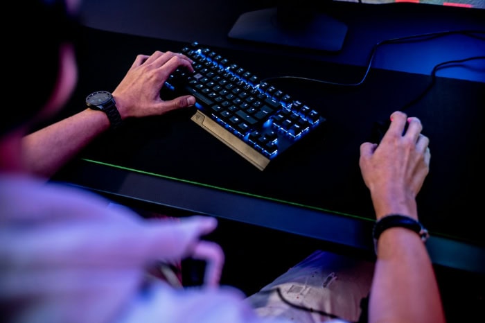 Close up of hands on keyboard and mouse during gaming