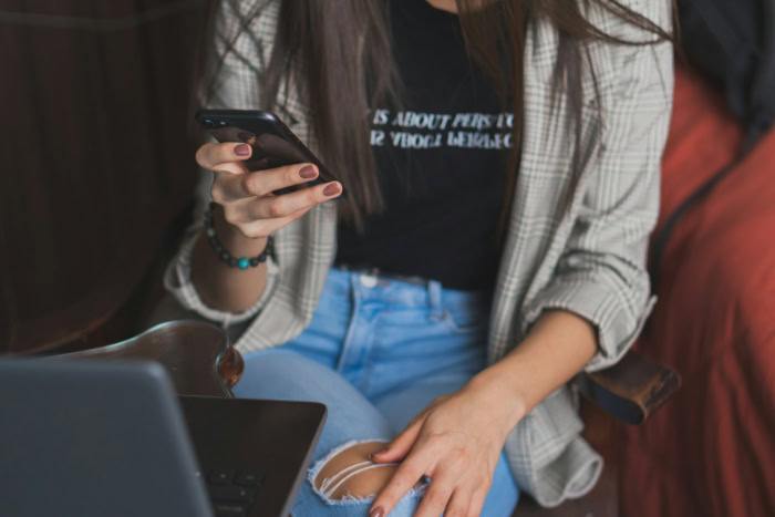 Close up of hands typing a message on smartphone