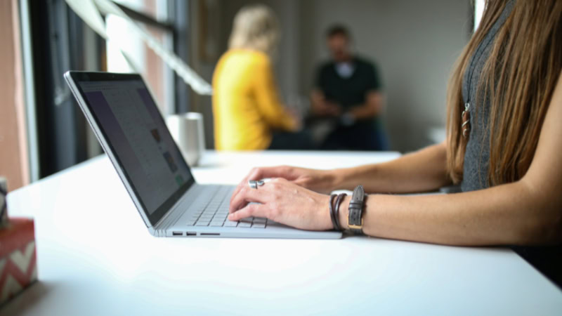 Close up of hands typing on a laptop
