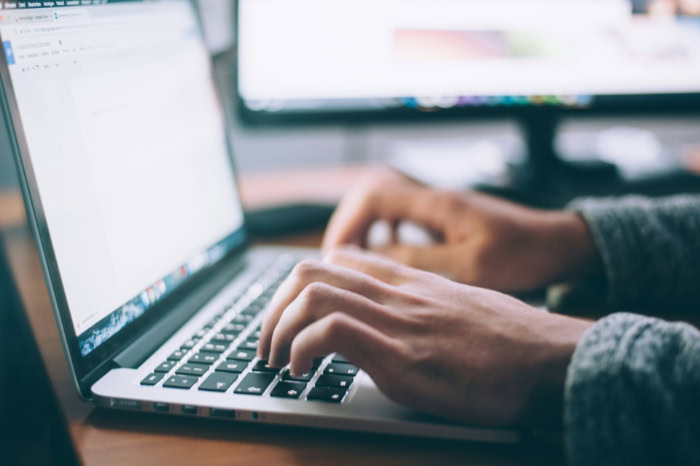 Close up of hands typing on laptop
