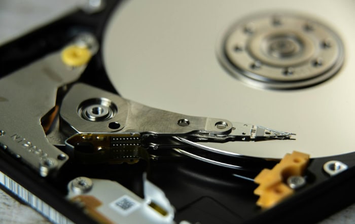 Close up of hard drive internals showing read write head and platter