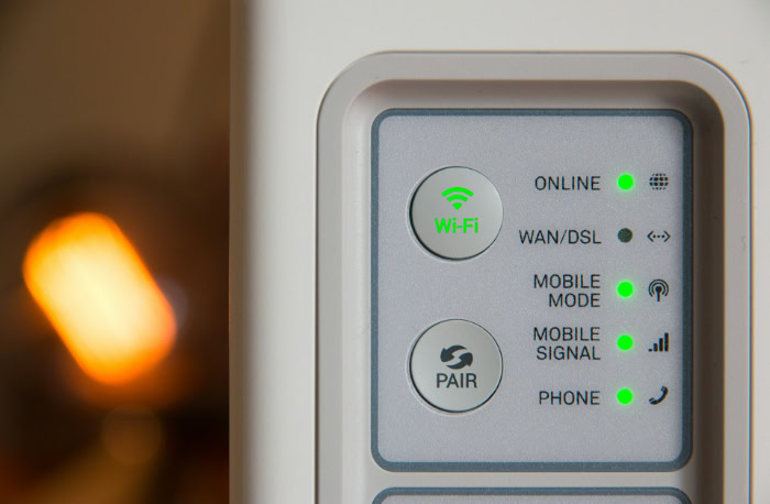Close up of modem panel showing green status lights