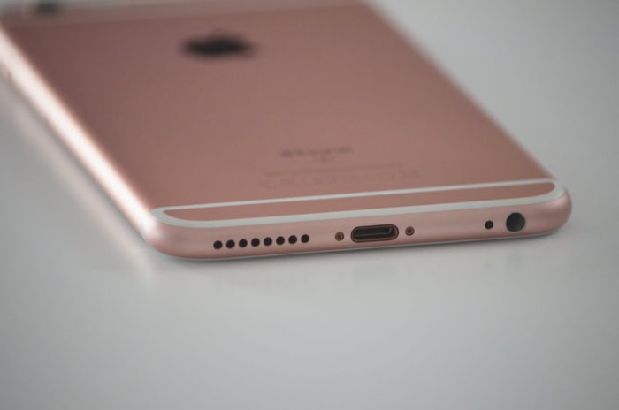 Close up of rose gold iPhone charging port and speakers