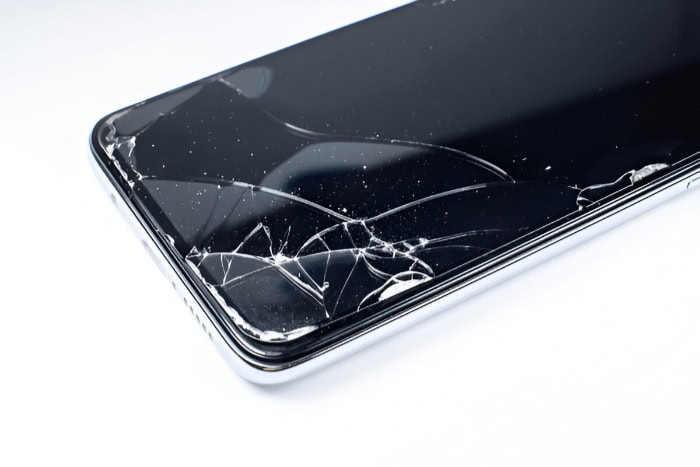 Close up of shattered smartphone screen corner