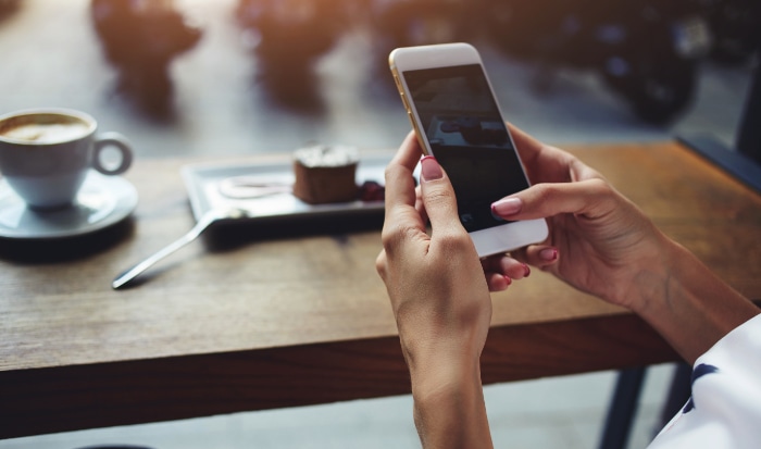 Close up of womens hands holding smartphone