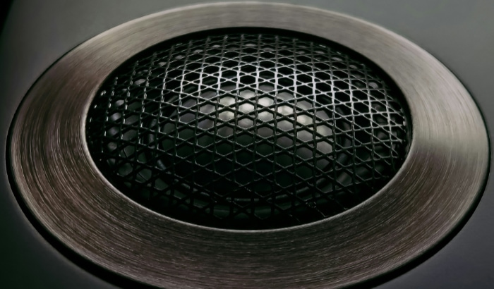 Close up view of a speaker grille showcasing its intricate mesh