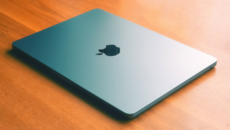 Closed midnight blue MacBook Air on wooden table