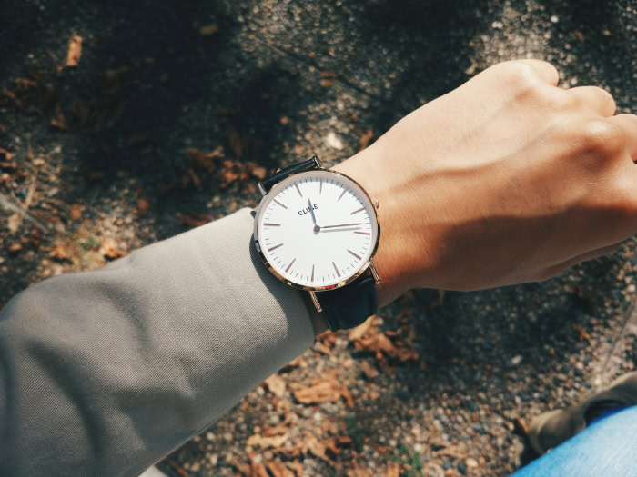 Cluse watch with black leather strap on wrist