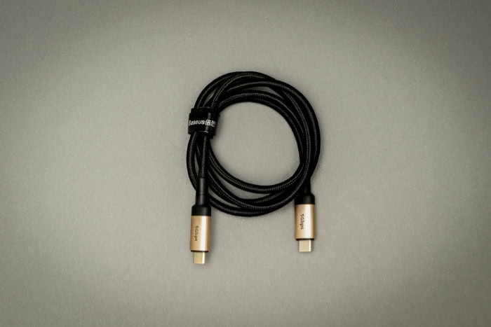 Coiled black USB C cable with gold connectors