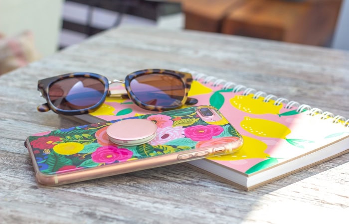 Colorful floral phone case with sunglasses and notebook