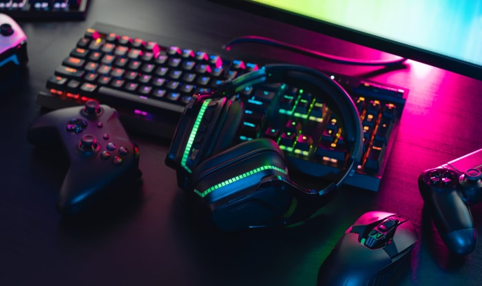 Colorful gaming setup with keyboard controller mouse and headphones