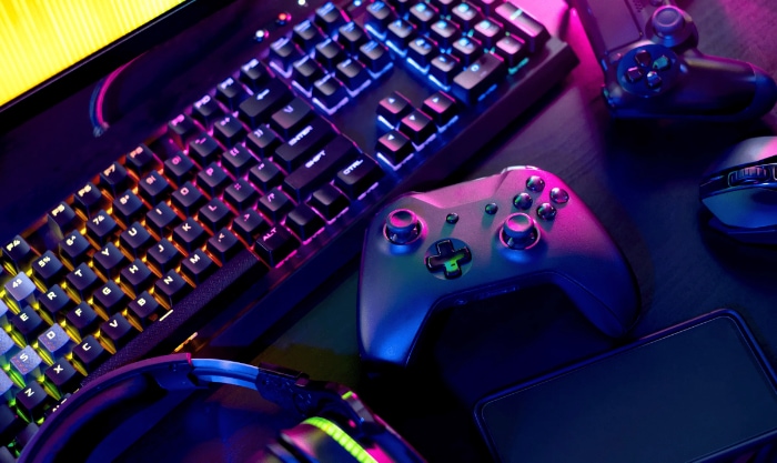 Colorful gaming setup with mechanical keyboard and controllers