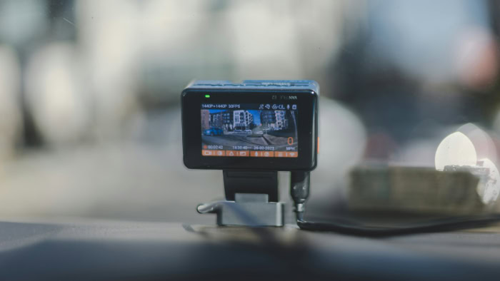 Compact dashcam mounted on a car dashboard