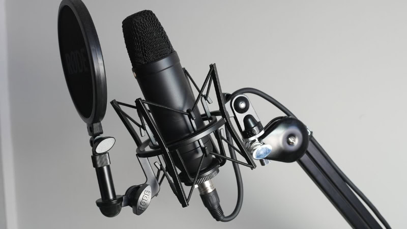 Condenser microphone with shock mount on boom arm
