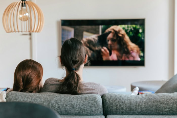 Couple sitting on a couch watching TV together