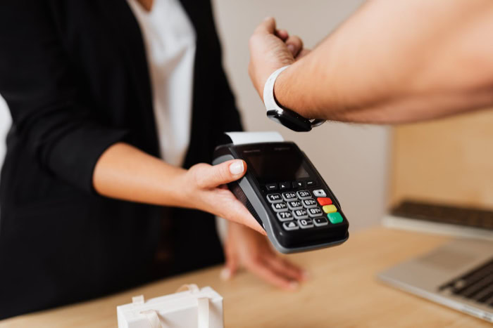 Customer making a contactless payment with a smartwatch