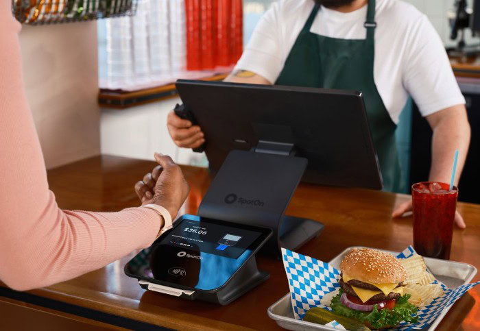 Customer making contactless payment with smartwatch at counter