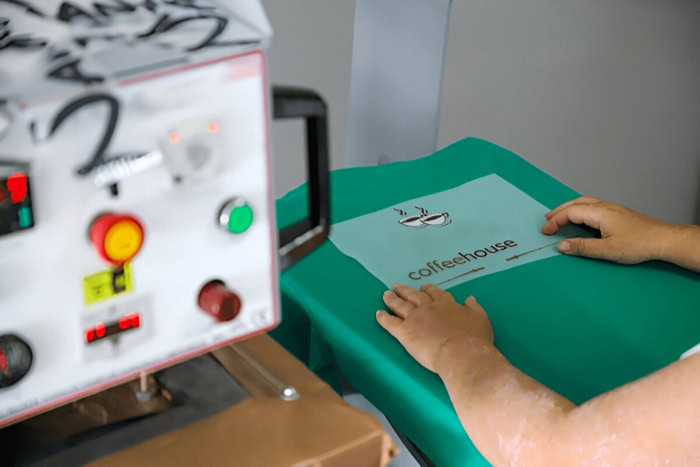 DTF printing transfer applied to green T shirt with heat press