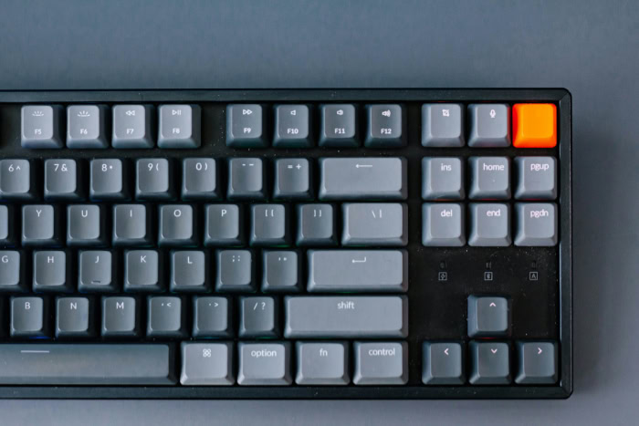 Dark gray mechanical keyboard with orange accent keycap