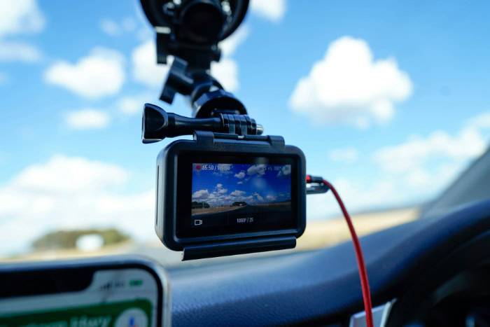 Dashcam mounted on car windshield recording road