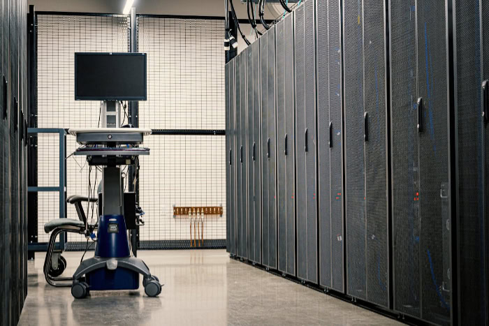 Data center aisle with server cabinets and monitoring station