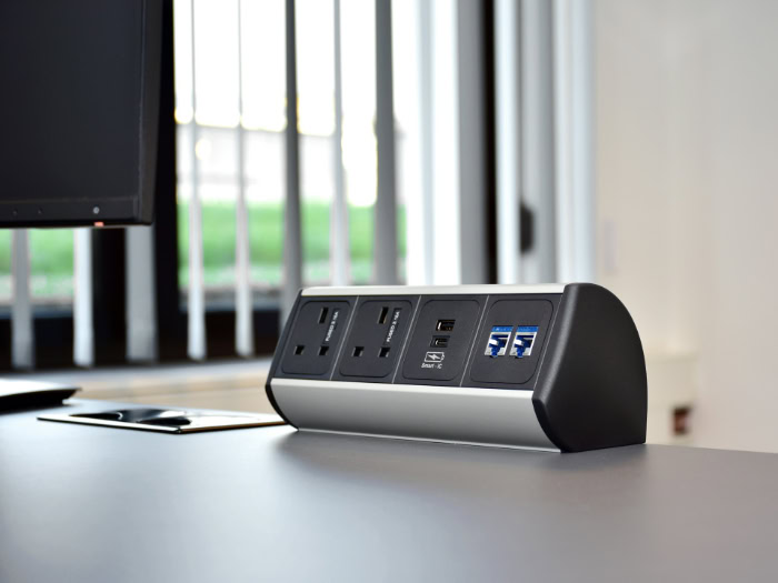 Desktop power module with outlets on office desk