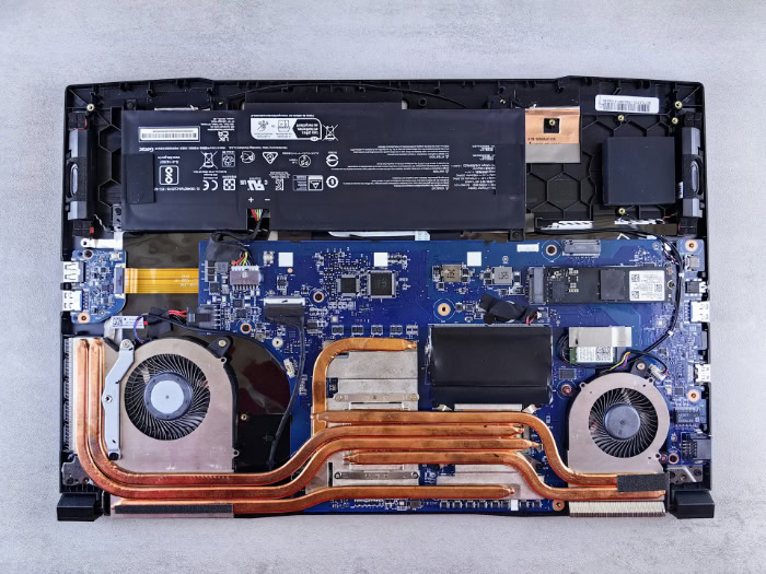 Disassembled MSI laptop showing battery motherboard and cooling fans