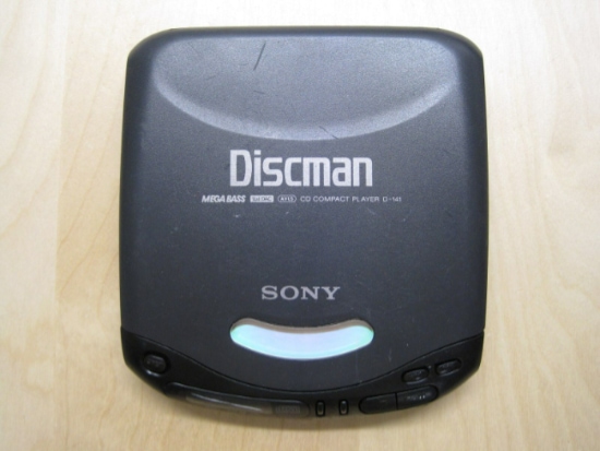 Black discman on wooden surface