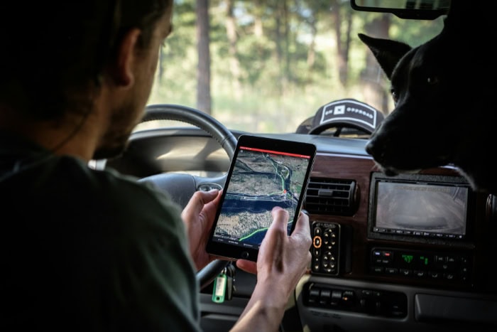 Driver using tablet with satellite map in off road vehicle