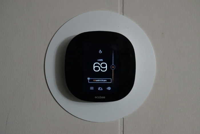 Ecobee smart thermostat displaying 69 degrees on black digital screen