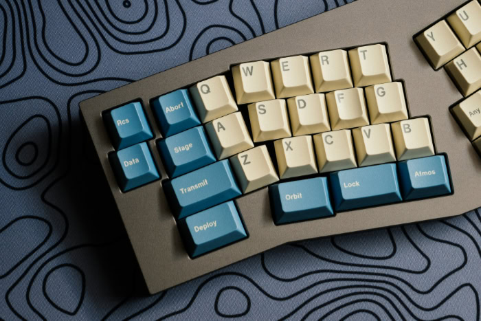Ergonomic keyboard with cream and blue space themed keycaps