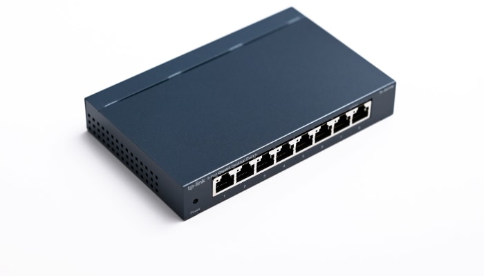 Black tp-link ethernet switch on white surface