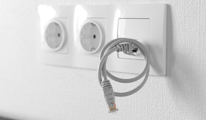 Ethernet cable plugged to wall socket