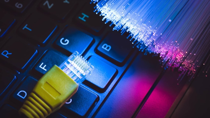 Fiber optic cable on a keyboard symbolizing high speed internet