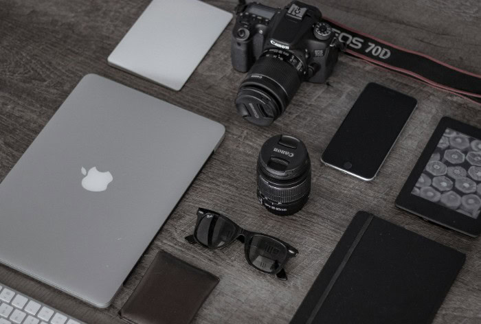 Flat lay of laptop DSLR camera and accessories