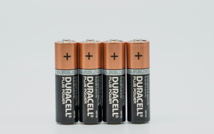 Four Duracell AA batteries on a plain white background