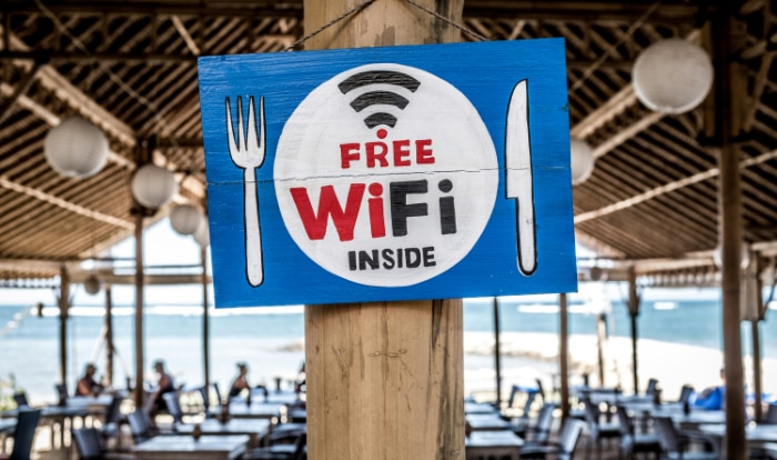 Free WiFi sign with fork and knife symbols at a beachside restaurant